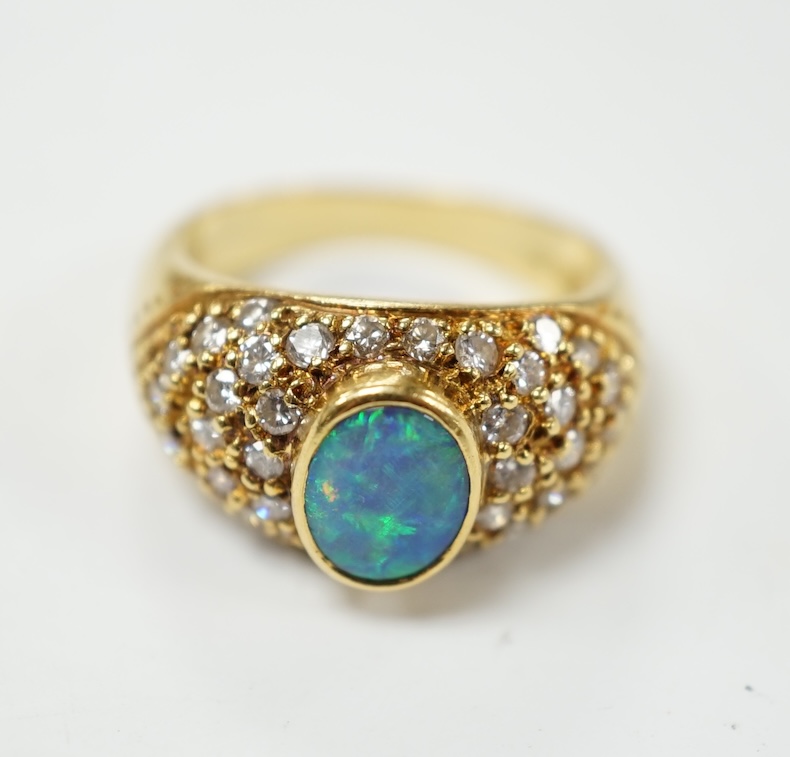 A modern 750 yellow metal and back opal set dress ring with diamond cluster set shoulders, size L, gross weight 6.9 grams. Condition - fair